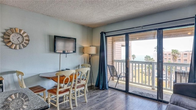 3938 Surfside Blvd Unit 3336, Corpus Christi, TX 78402 - dining space with wood finished floors and a textured ceiling