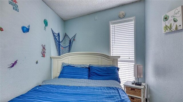 3938 Surfside Blvd Unit 3336, Corpus Christi, TX 78402 - bedroom featuring a textured wall and a textured ceiling