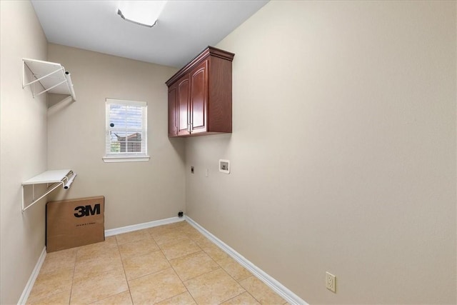 washroom with light tile patterned floors, cabinet space, baseboards, and hookup for a washing machine
