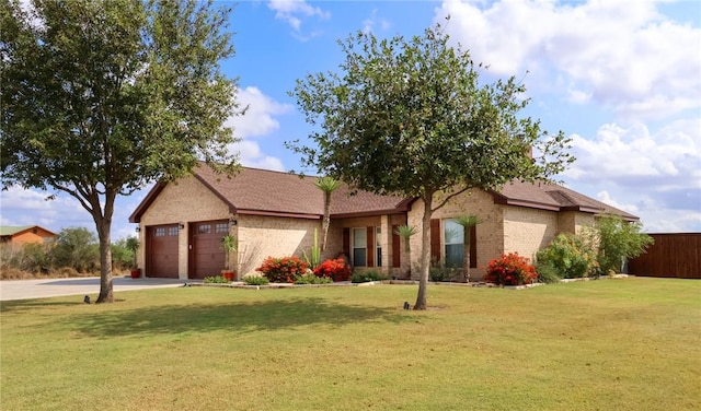 single story home with concrete driveway, fence, brick siding, a front lawn, and a garage