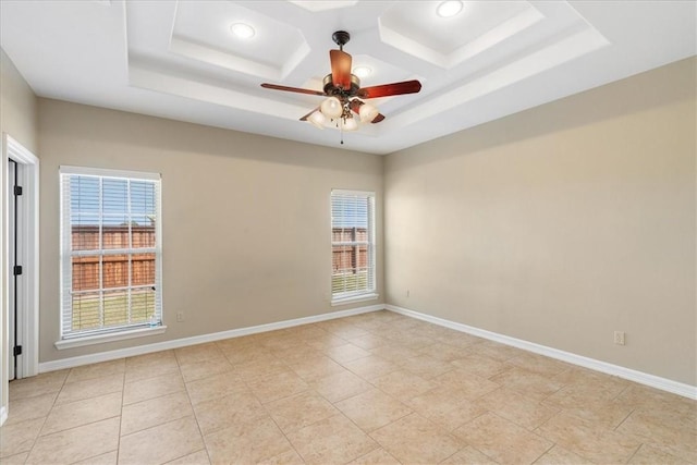spare room with baseboards, ceiling fan, and coffered ceiling