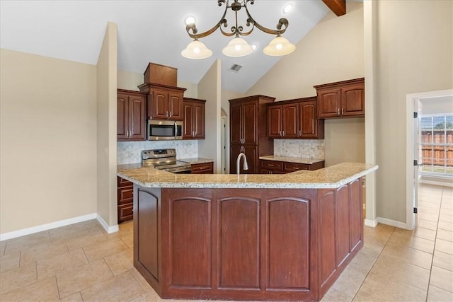 kitchen with light countertops, visible vents, stainless steel appliances, and a spacious island