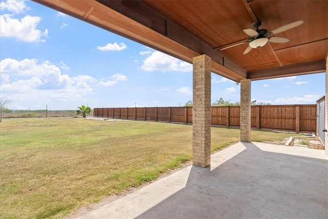 view of yard with a fenced backyard, a ceiling fan, and a patio area