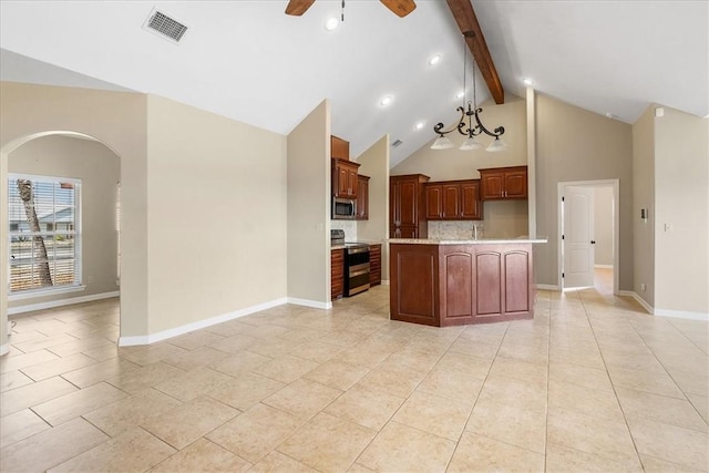kitchen featuring light countertops, beamed ceiling, visible vents, a ceiling fan, and appliances with stainless steel finishes