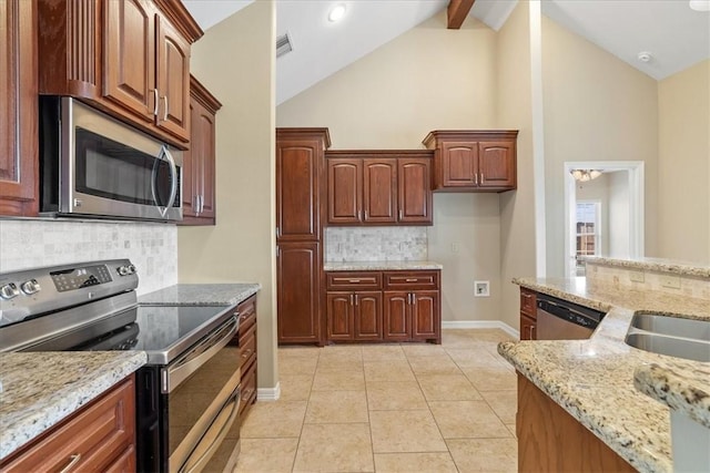 kitchen featuring light tile patterned flooring, beam ceiling, light stone counters, visible vents, and appliances with stainless steel finishes