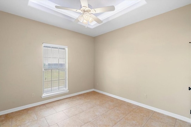 unfurnished room with baseboards, light tile patterned flooring, and a ceiling fan