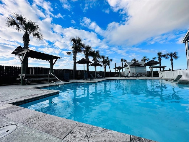 pool featuring a patio and fence