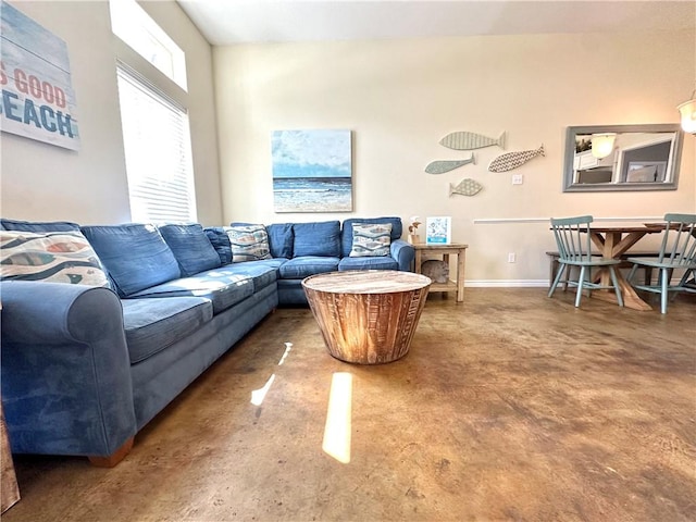 living area with concrete floors and baseboards