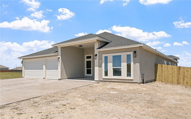 714 Papa Mori Dr, Corpus Christi, TX 78415 - view of front facade with a garage, fence, concrete driveway, and stucco siding