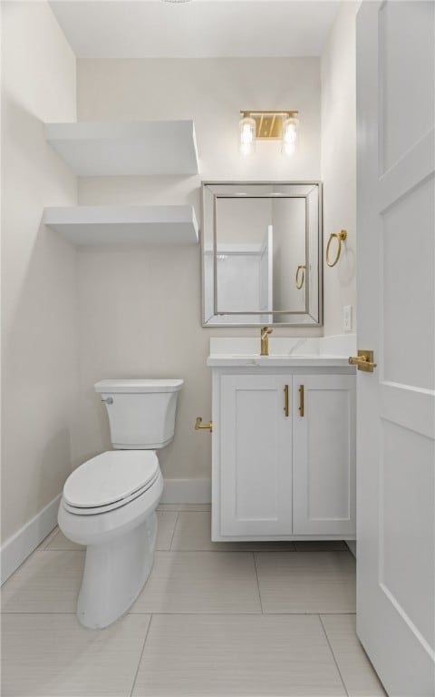 714 Papa Mori Dr, Corpus Christi, TX 78415 - bathroom with toilet, tile patterned floors, vanity, and baseboards