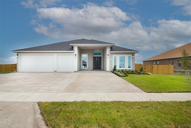 714 Papa Mori Dr, Corpus Christi, TX 78415 - prairie-style home with stucco siding, driveway, a garage, and a shingled roof