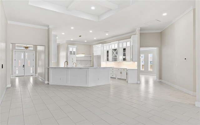714 Papa Mori Dr, Corpus Christi, TX 78415 - kitchen featuring backsplash, white cabinetry, glass insert cabinets, light countertops, and crown molding