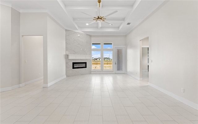 714 Papa Mori Dr, Corpus Christi, TX 78415 - unfurnished living room featuring a ceiling fan, coffered ceiling, a premium fireplace, beam ceiling, and a high ceiling