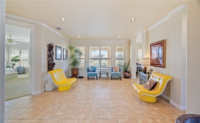 living area featuring crown molding and light tile patterned floors