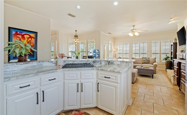 kitchen featuring black cooktop, white cabinetry, light tile patterned floors, ornamental molding, and pendant lighting