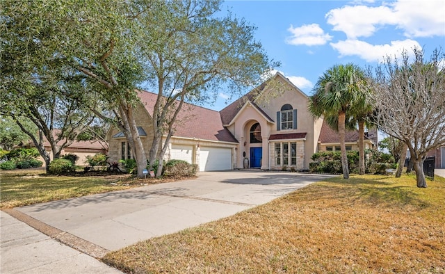 view of front of house with a garage and a front yard