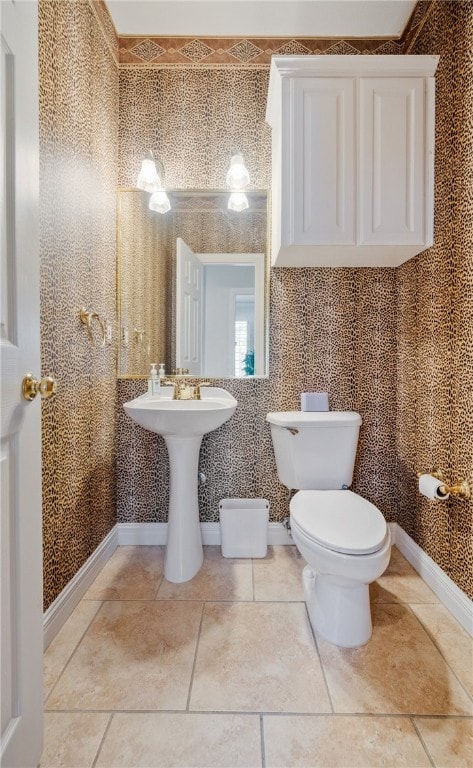 bathroom with tile patterned floors, toilet, and sink