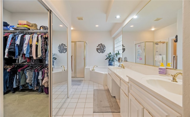 bathroom featuring vanity, shower with separate bathtub, and tile patterned flooring