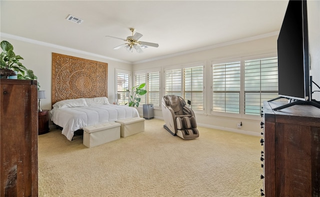 bedroom with ornamental molding, light colored carpet, and ceiling fan