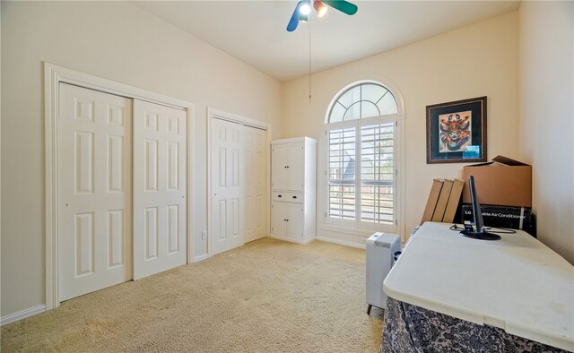 office space featuring light carpet and ceiling fan