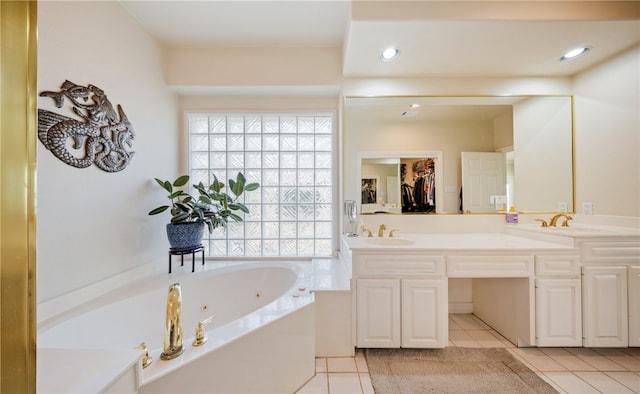 bathroom with vanity, tile patterned flooring, and a tub