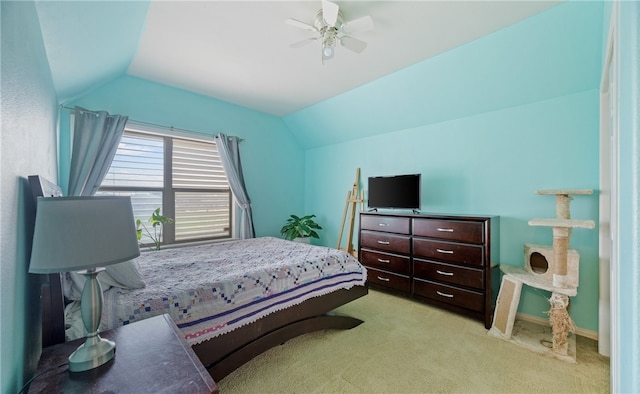 carpeted bedroom featuring ceiling fan and vaulted ceiling