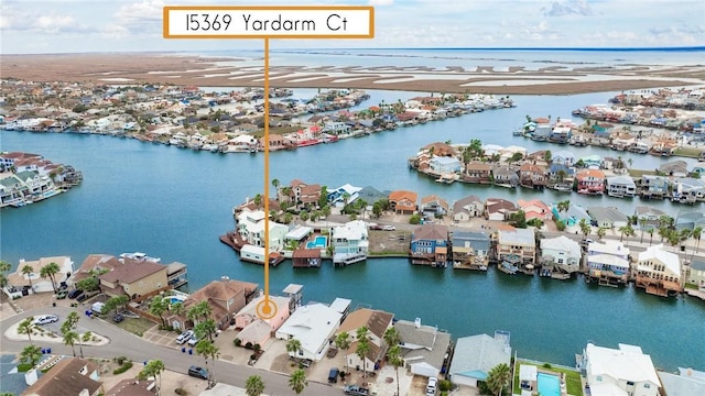 drone / aerial view featuring a residential view and a water view