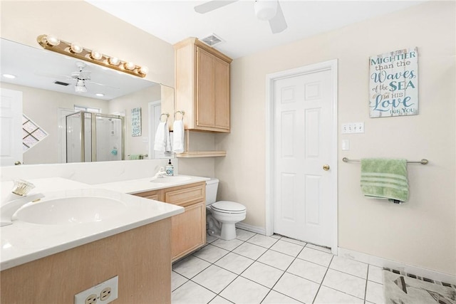 bathroom with double vanity, a shower stall, a ceiling fan, and a sink