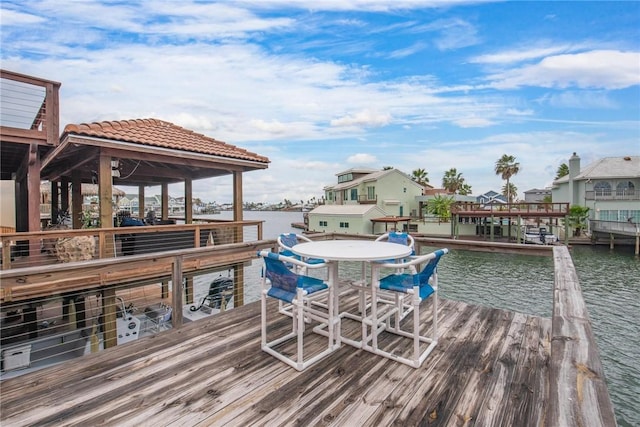view of dock with a gazebo and a water view