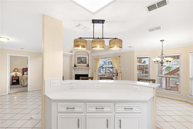 kitchen featuring light tile patterned flooring, visible vents, and light countertops