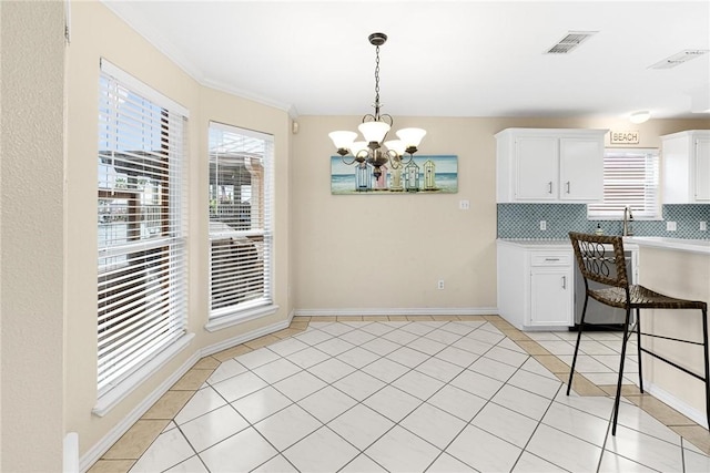 kitchen featuring light tile patterned floors, a notable chandelier, visible vents, and plenty of natural light