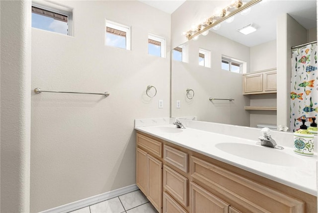 bathroom featuring double vanity, a sink, and a wealth of natural light