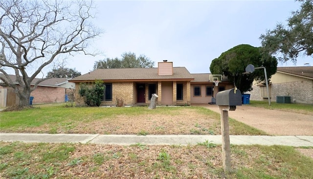 ranch-style home with central AC unit and a front yard