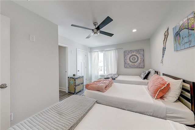 bedroom with hardwood / wood-style flooring and ceiling fan