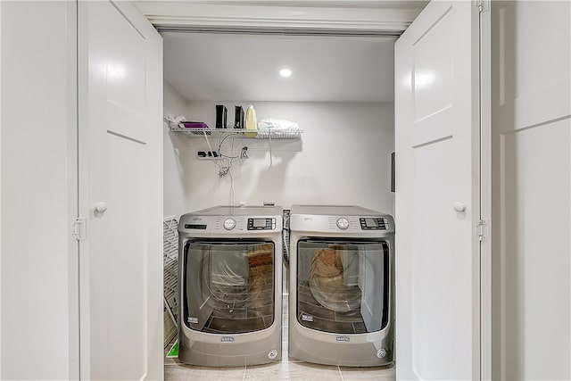 washroom with tile patterned flooring and washer and dryer