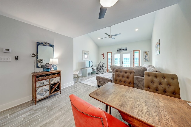 living room with french doors, light hardwood / wood-style floors, lofted ceiling, and ceiling fan