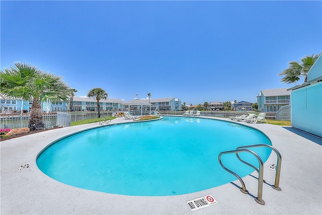 view of swimming pool with a water view