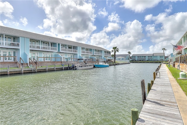 dock area featuring a water view and a balcony