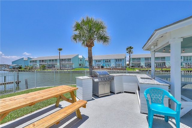 view of patio with sink and a water view