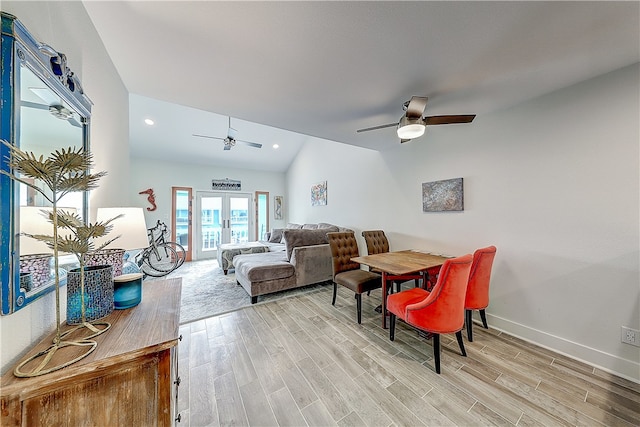 dining space featuring light wood-type flooring, lofted ceiling, french doors, and ceiling fan