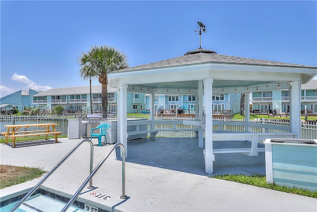 view of patio with a water view and a gazebo