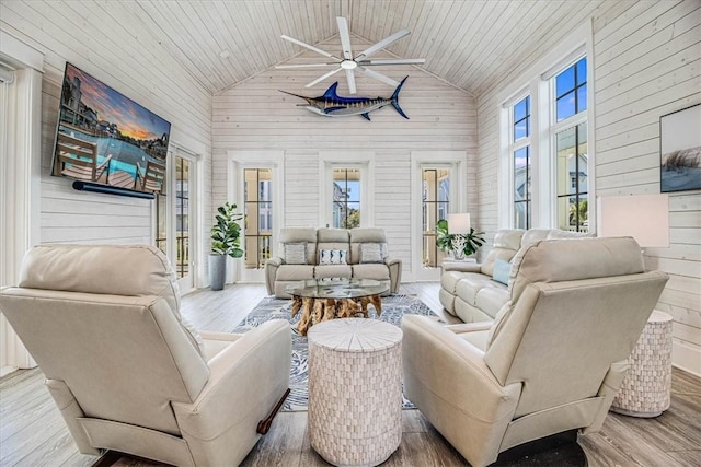 interior space featuring high vaulted ceiling, wooden ceiling, wooden walls, and wood finished floors