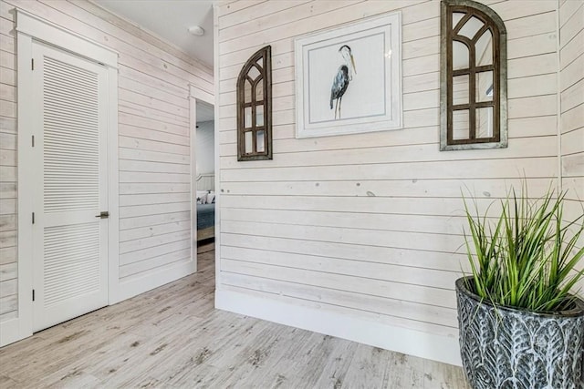 interior space featuring wood finished floors and wooden walls