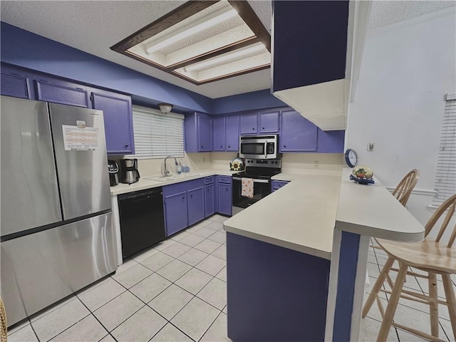 4241 Lake Tahoe Dr, Corpus Christi, TX 78413 - kitchen featuring blue cabinets, a peninsula, a sink, light countertops, and appliances with stainless steel finishes