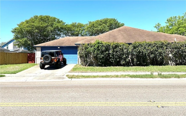 4241 Lake Tahoe Dr, Corpus Christi, TX 78413 - view of front of house featuring fence, a shingled roof, and a garage