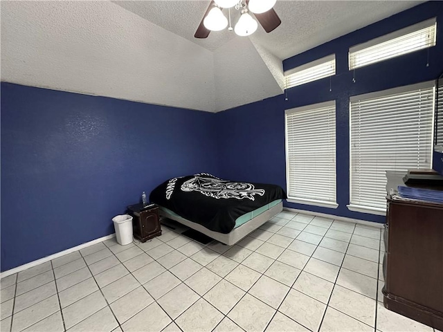 4241 Lake Tahoe Dr, Corpus Christi, TX 78413 - bedroom featuring lofted ceiling, light tile patterned flooring, baseboards, a textured ceiling, and ceiling fan