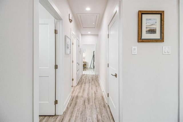 hall featuring recessed lighting, light wood-type flooring, baseboards, and attic access