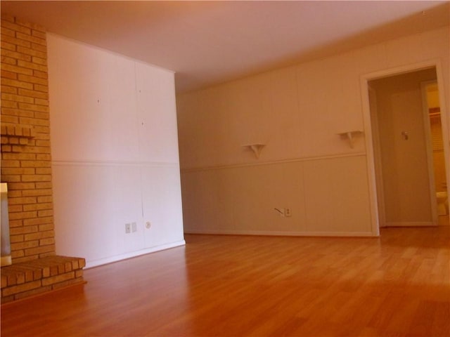 unfurnished living room featuring wood finished floors