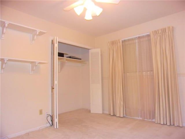 unfurnished bedroom featuring carpet and a closet