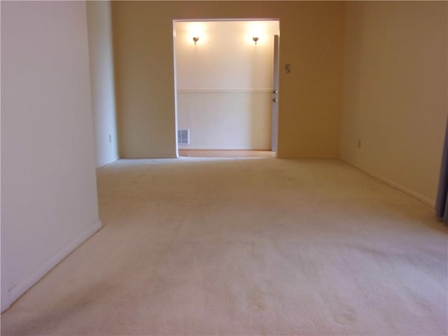 empty room featuring carpet floors and visible vents